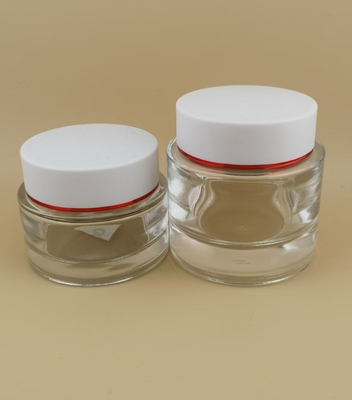 Vaso di crema di vetro trasparente con coperchio a vite bianco per lozione femminile